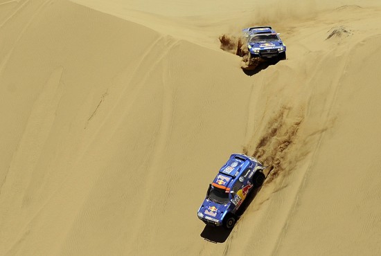 Qatar's driver Nasser Al-Attiyah steers his Volkswagen (bottom) with German co-driver Timo Gottschalk, followed by Spain's driver Carlos Sainz with co-driver Lucas Cruz on January 10, 2011 on the stage 8 Atacama - Copiapo of the Dakar 2011 Rally. (DANIEL GARCIA/AFP/Getty Images)